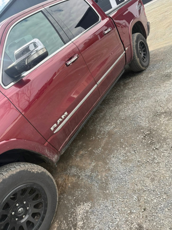 Red Ram 1500 pickup covered in mud and road grime before detailing in Chippewa Falls, WI